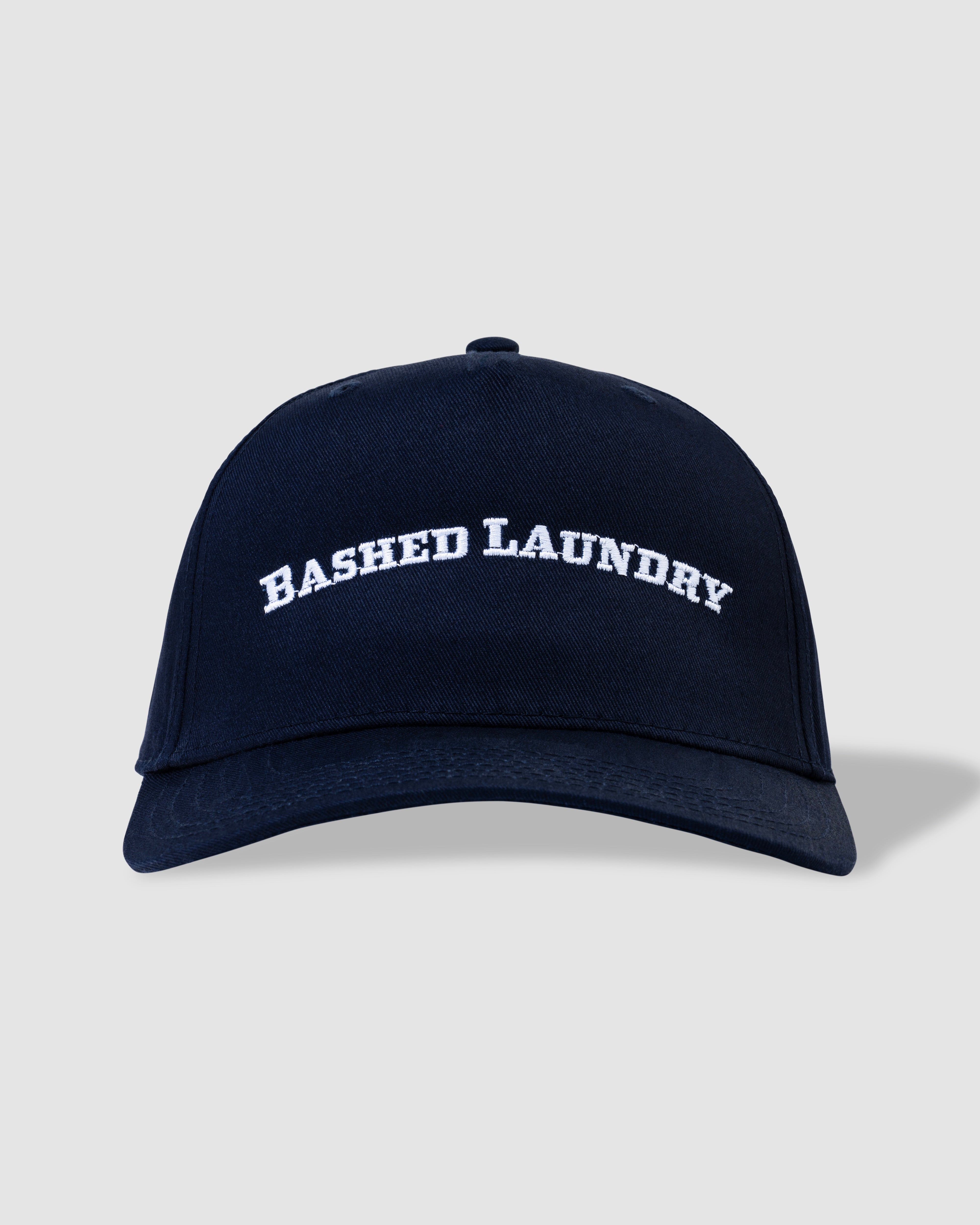 Men’s and unisex ink blue trucker hat with Bashed Laundry embroidery, front view